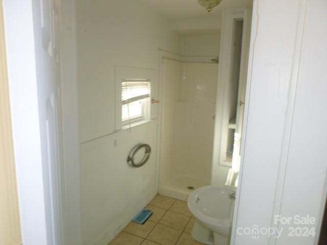 bathroom featuring tile patterned floors and a shower