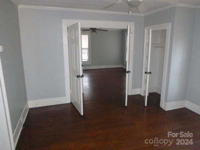 interior space featuring dark hardwood / wood-style flooring and crown molding