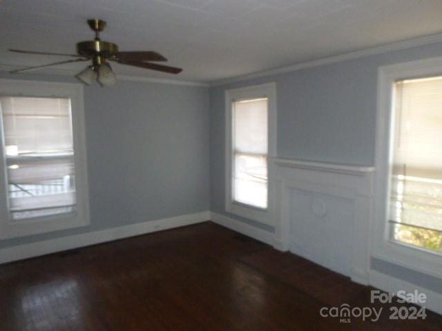 spare room featuring ceiling fan, crown molding, and dark hardwood / wood-style floors