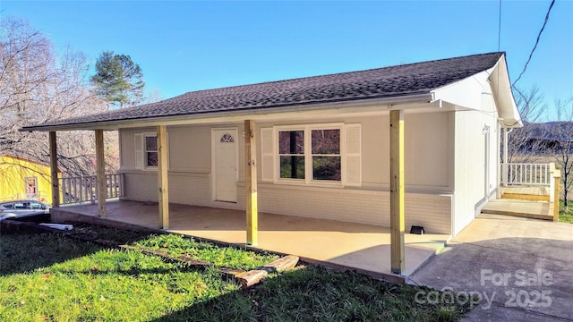 rear view of property featuring a patio