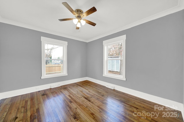 spare room with hardwood / wood-style flooring, ornamental molding, and ceiling fan