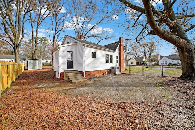 rear view of house with central AC unit