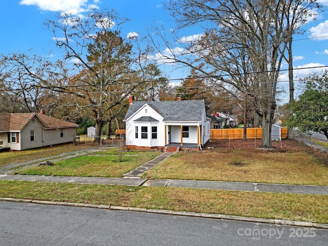 bungalow-style home with a front lawn