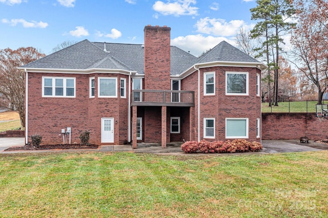 rear view of house with a yard