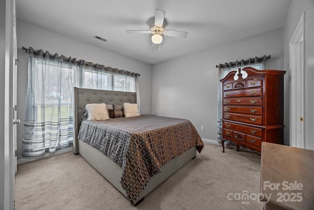 bedroom featuring light colored carpet and ceiling fan