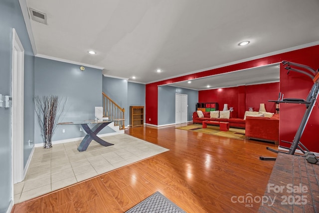 interior space with ornamental molding and light hardwood / wood-style floors