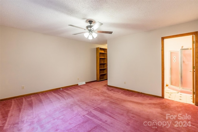 carpeted empty room with ceiling fan and a textured ceiling