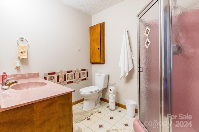 bathroom with tile patterned floors, an enclosed shower, vanity, a textured ceiling, and toilet