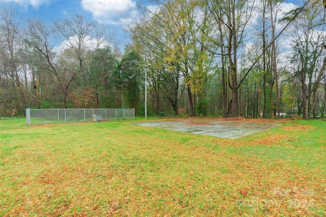 view of yard with basketball hoop