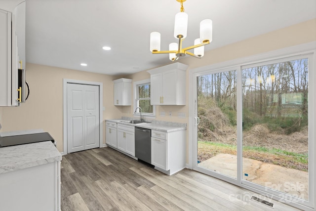 kitchen with white cabinetry, plenty of natural light, dishwasher, and sink