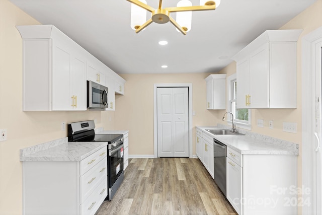 kitchen with sink, light wood-type flooring, white cabinetry, and stainless steel appliances