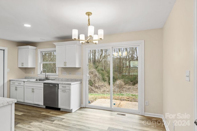 kitchen with dishwasher, white cabinets, light hardwood / wood-style floors, and sink