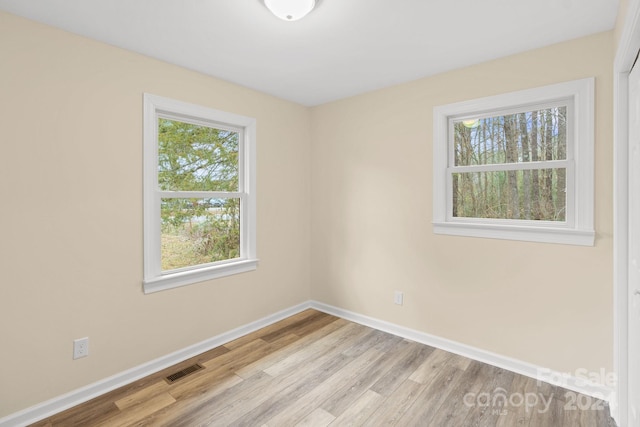 spare room featuring light hardwood / wood-style floors