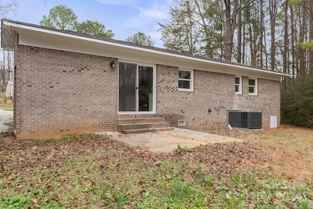 rear view of property featuring cooling unit and a patio area