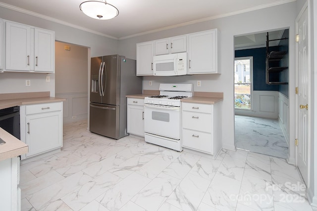 kitchen with crown molding, white cabinets, and white appliances