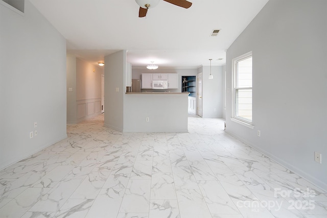 unfurnished living room with ceiling fan