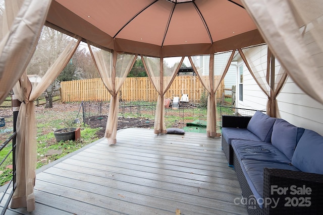 wooden terrace with a gazebo and an outdoor hangout area