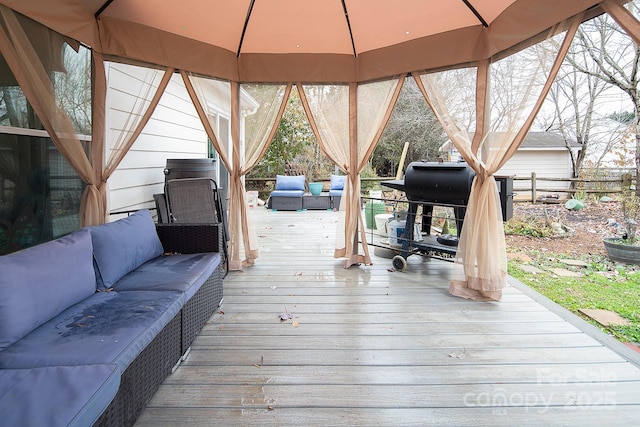 wooden deck with outdoor lounge area and grilling area