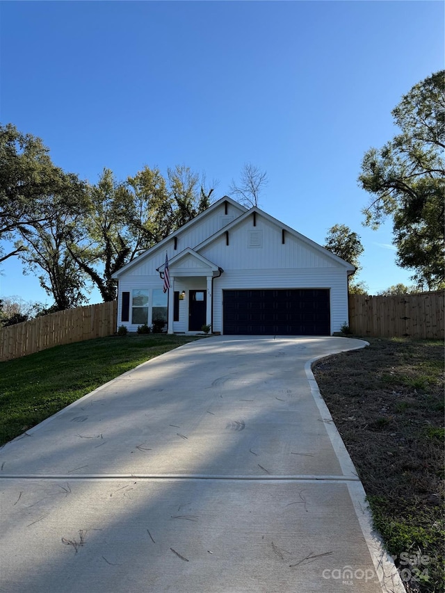 view of front of property with a garage and a front yard