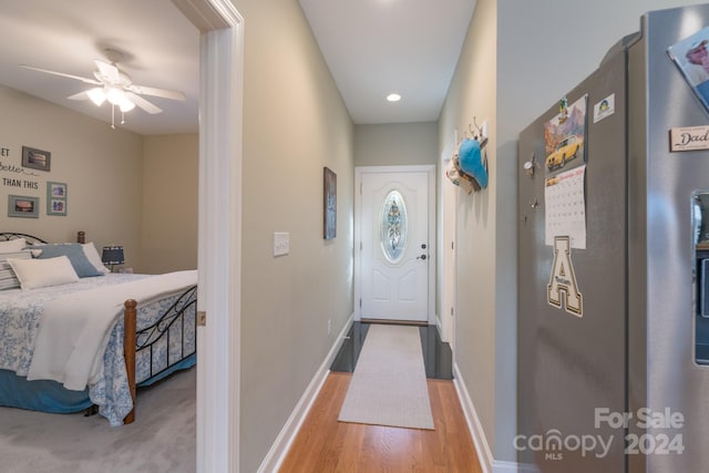 entryway with ceiling fan and light hardwood / wood-style floors