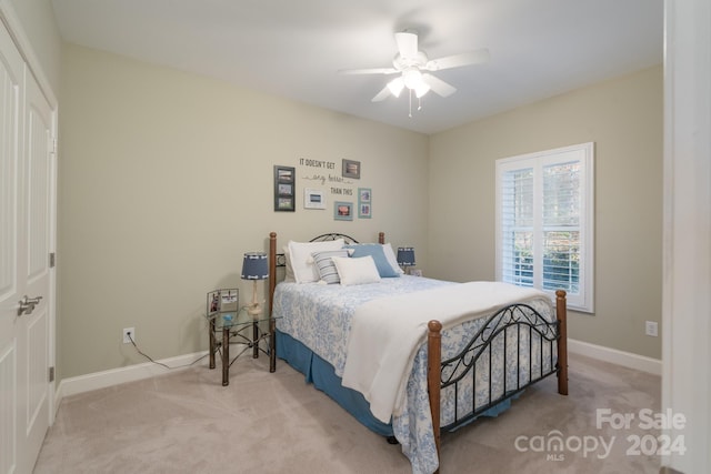 bedroom featuring ceiling fan and light carpet