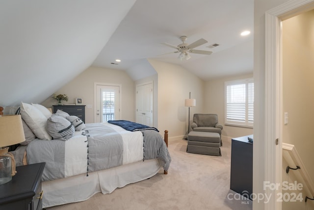 carpeted bedroom with ceiling fan, a closet, and vaulted ceiling