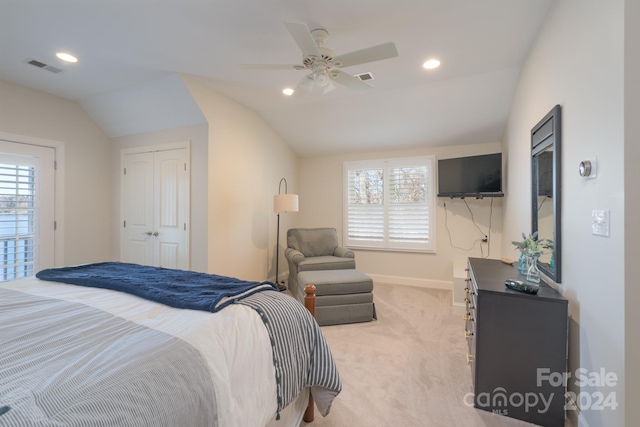 carpeted bedroom with ceiling fan, a closet, and lofted ceiling