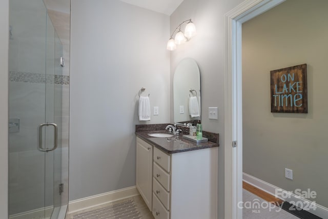 bathroom with vanity and an enclosed shower