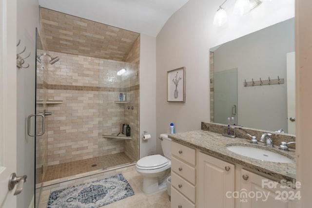 bathroom featuring vanity, lofted ceiling, tile patterned floors, toilet, and an enclosed shower