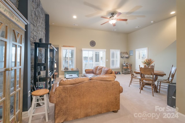 carpeted living room with ceiling fan