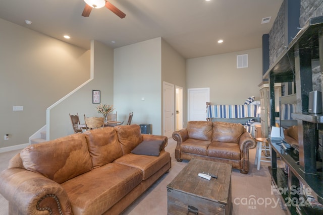 living room with light colored carpet and ceiling fan