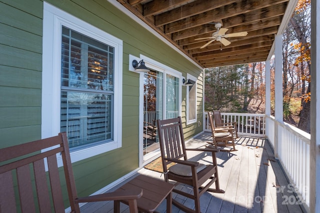 wooden terrace featuring ceiling fan and covered porch