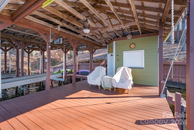 wooden terrace with ceiling fan and a dock