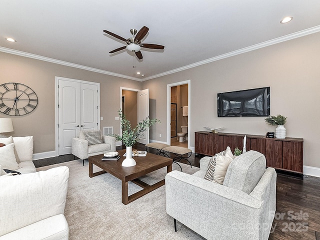 living room featuring ceiling fan, wood-type flooring, and crown molding