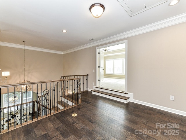 corridor featuring a notable chandelier, crown molding, and dark hardwood / wood-style floors