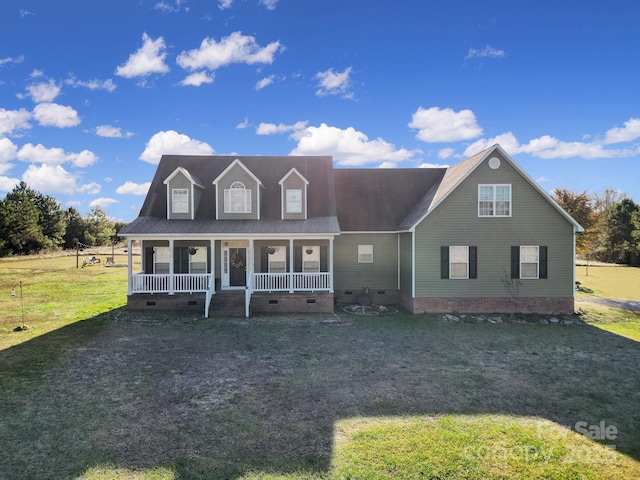 view of front facade featuring a front yard, covered porch, and crawl space