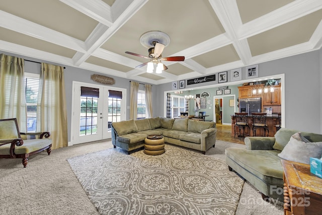 living area featuring ceiling fan, light carpet, french doors, and coffered ceiling