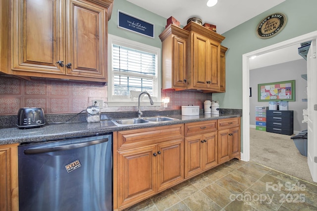 kitchen with brown cabinets, dark countertops, a sink, and dishwasher
