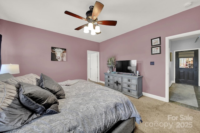 carpeted bedroom featuring baseboards and ceiling fan