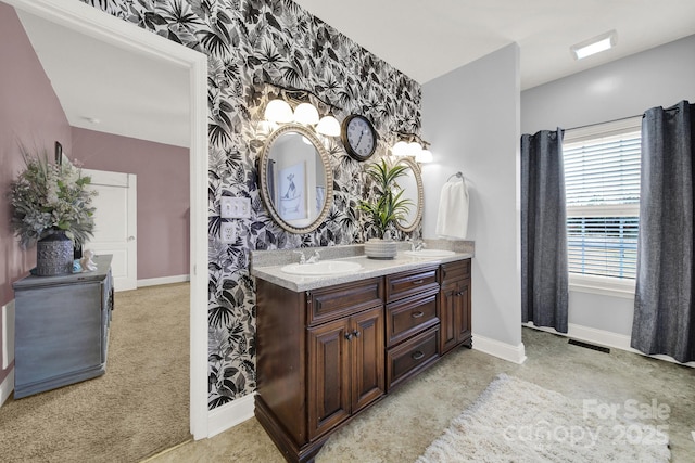 full bathroom featuring baseboards, a sink, visible vents, and wallpapered walls