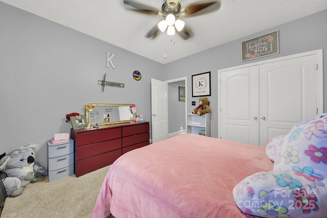 carpeted bedroom featuring a ceiling fan and a closet