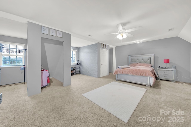 carpeted bedroom featuring a ceiling fan and visible vents