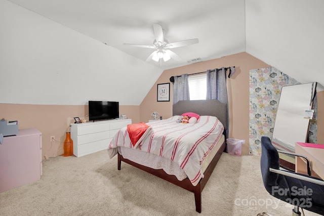 carpeted bedroom with ceiling fan, vaulted ceiling, and visible vents