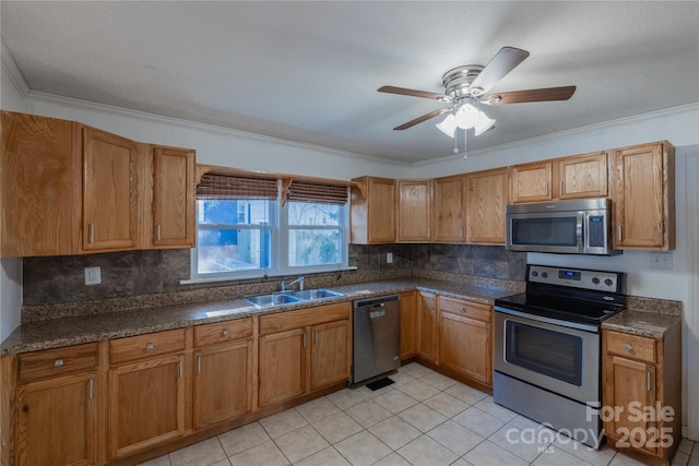 kitchen featuring appliances with stainless steel finishes, backsplash, ceiling fan, sink, and light tile patterned floors