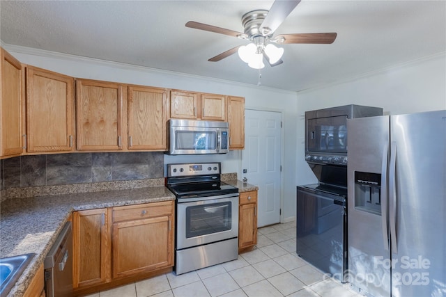 kitchen with decorative backsplash, appliances with stainless steel finishes, light tile patterned floors, and crown molding