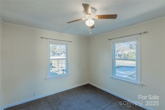 unfurnished room with carpet, ornamental molding, ceiling fan, and a healthy amount of sunlight