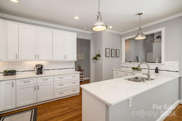 kitchen featuring white cabinets, dark hardwood / wood-style flooring, ceiling fan, and sink