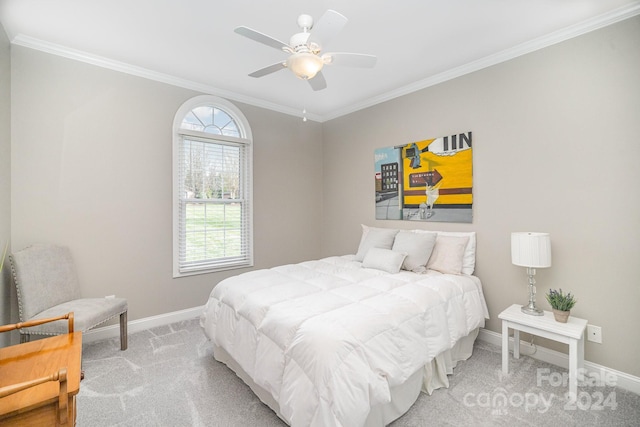 carpeted bedroom with ceiling fan and crown molding