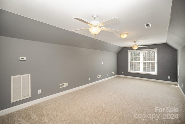 bonus room with ceiling fan, light colored carpet, and lofted ceiling