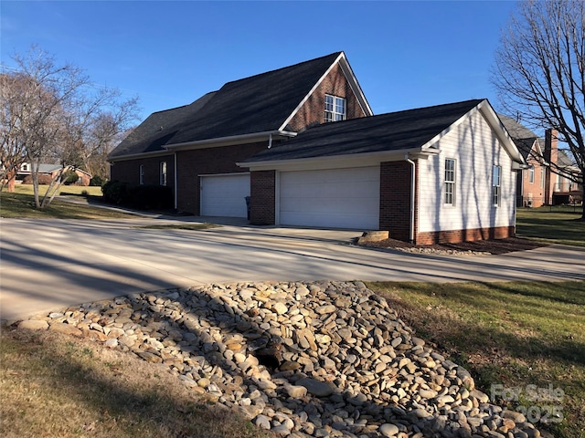 180 Sink Farm Rd, Mooresville, NC 28115 - view of property exterior featuring a garage, concrete driveway, and brick siding